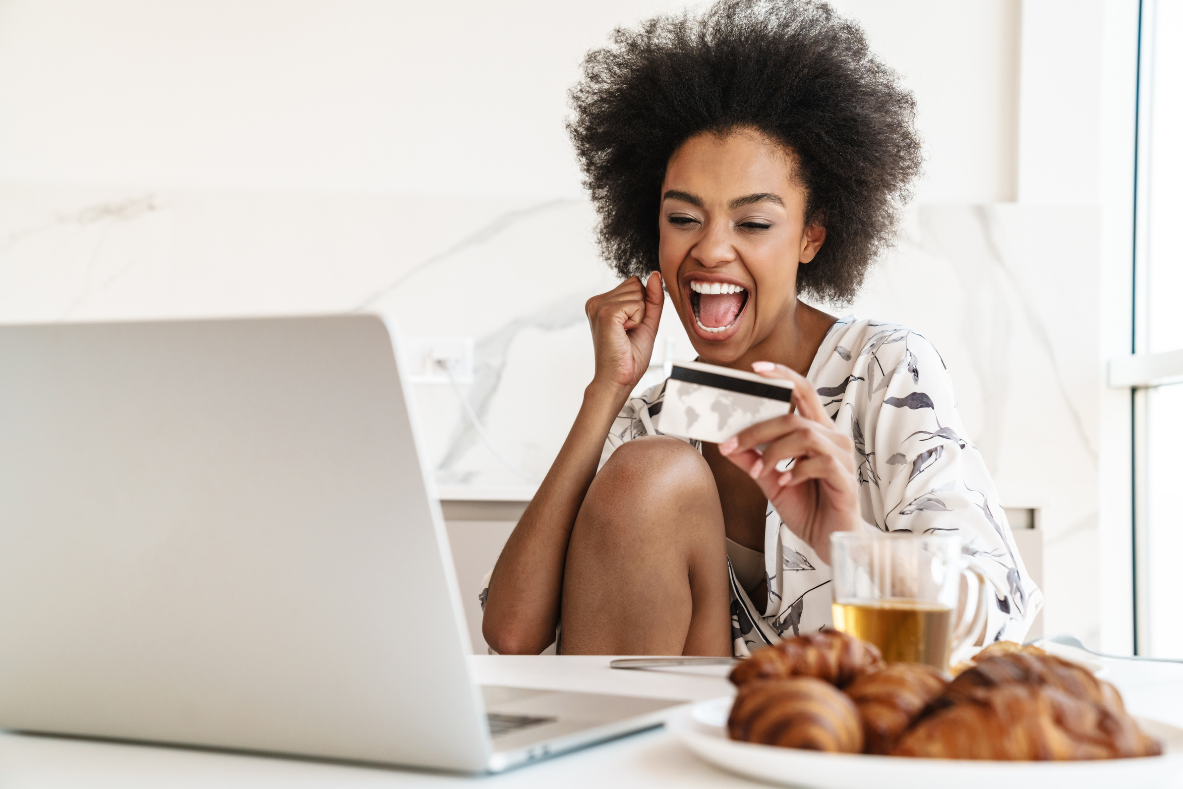 Excited Young Woman Holding Credit Card